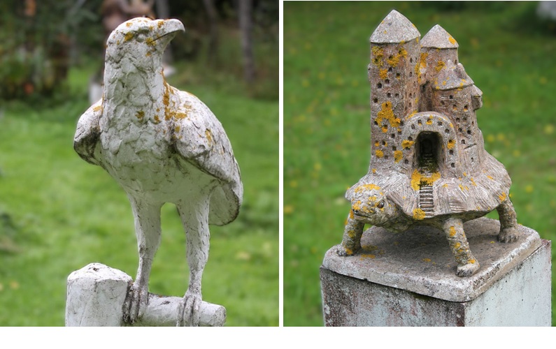 Two sculptures: on the left, an eagle turning its head, and on the right, a turtle. A fortress stands on the turtle’s back.