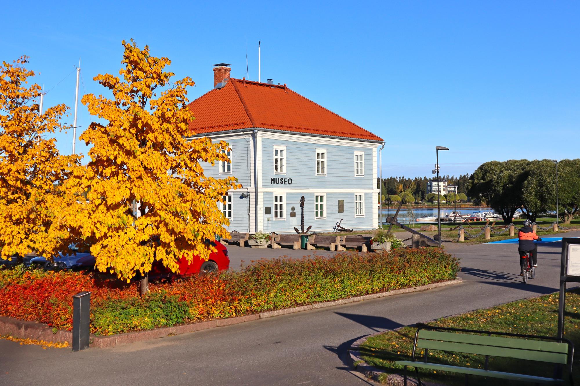 Pakkahuone Museum in an autumn landscape.