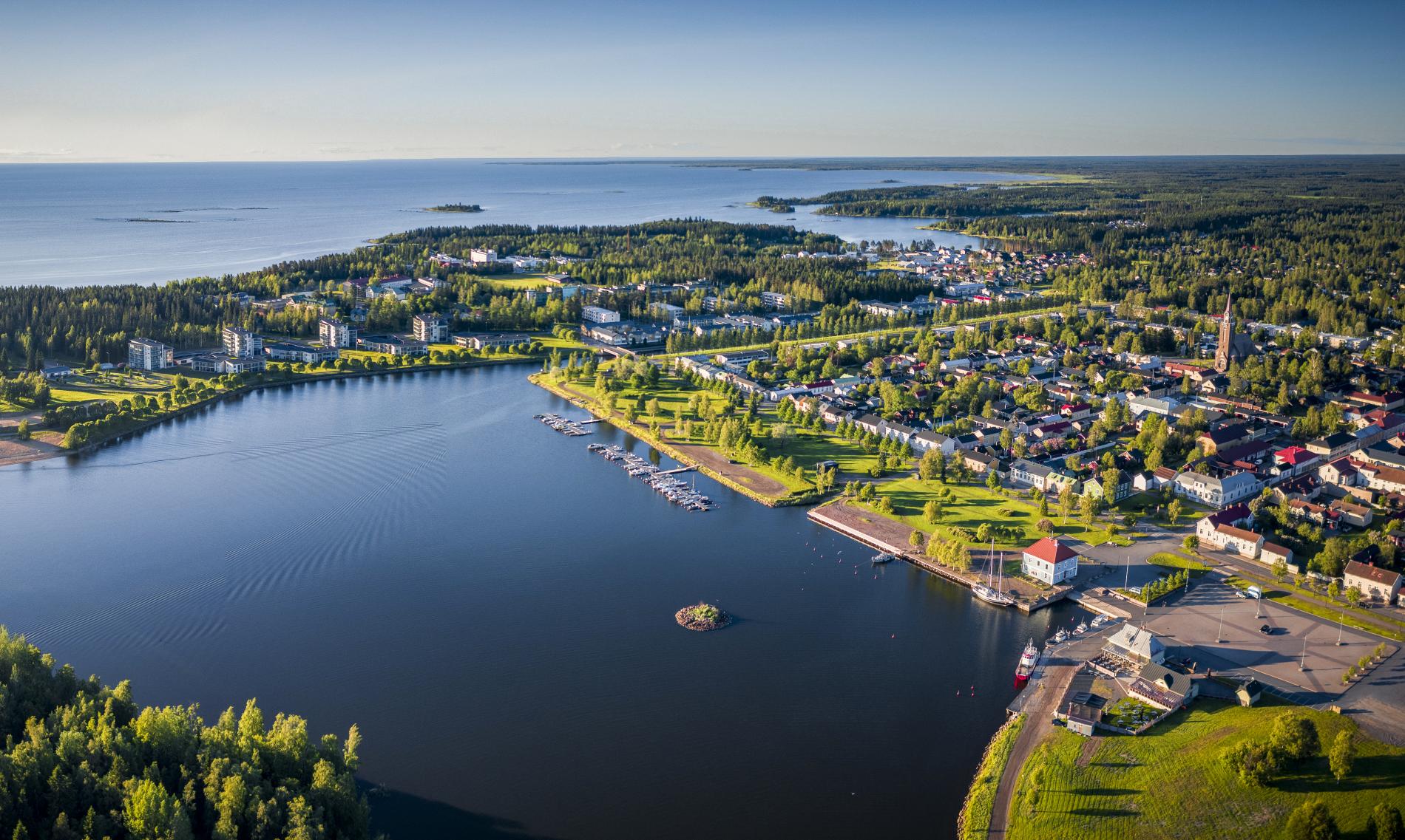 Summertime Raahe photographed from above. In the foreground, the dark Pikkulahti bay.